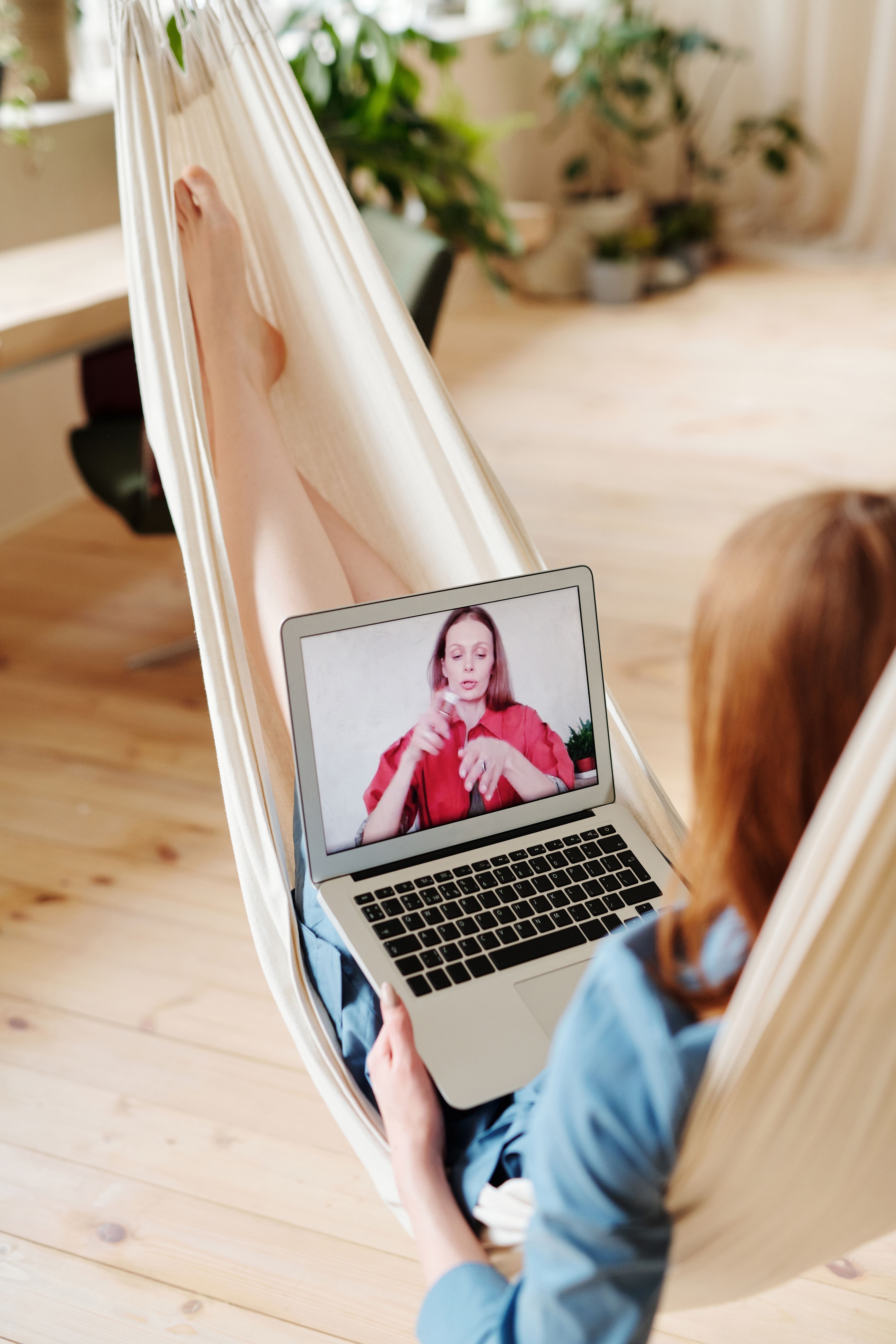 Person taking part in an online counseling session by video call on a laptop